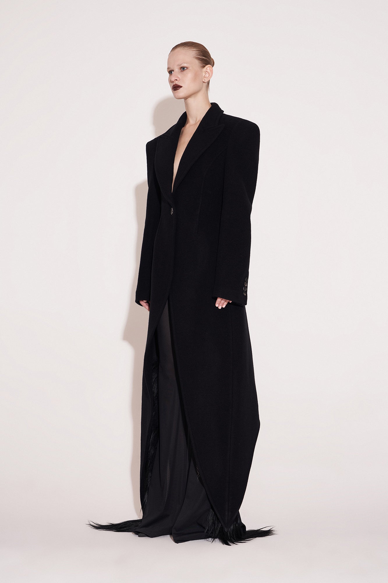 Wool coat with wide shoulders and swallowtail hem