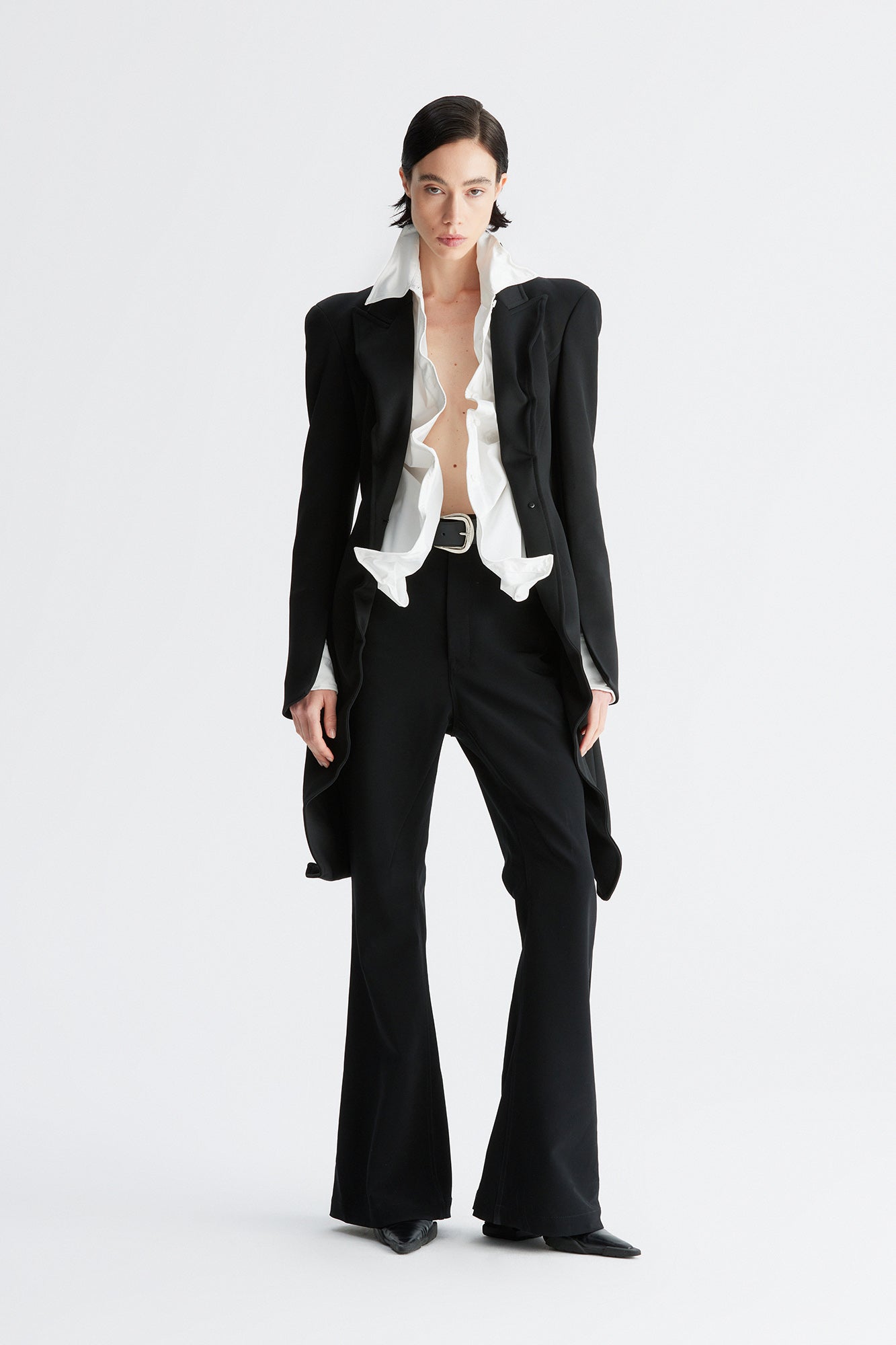 A round-shouldered suit with a swallow-tail hem