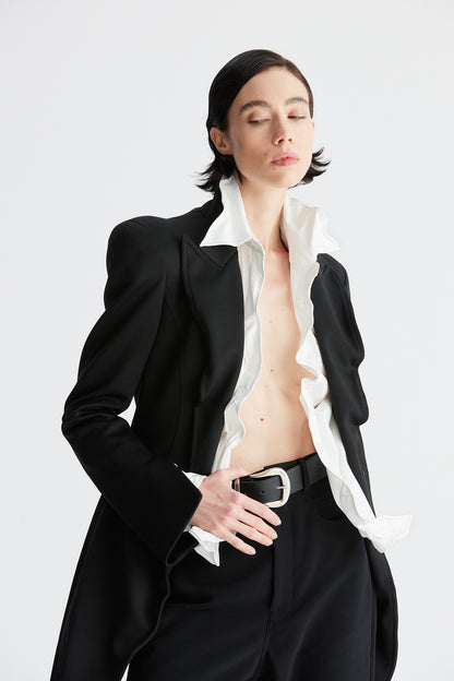 A round-shouldered suit with a swallow-tail hem